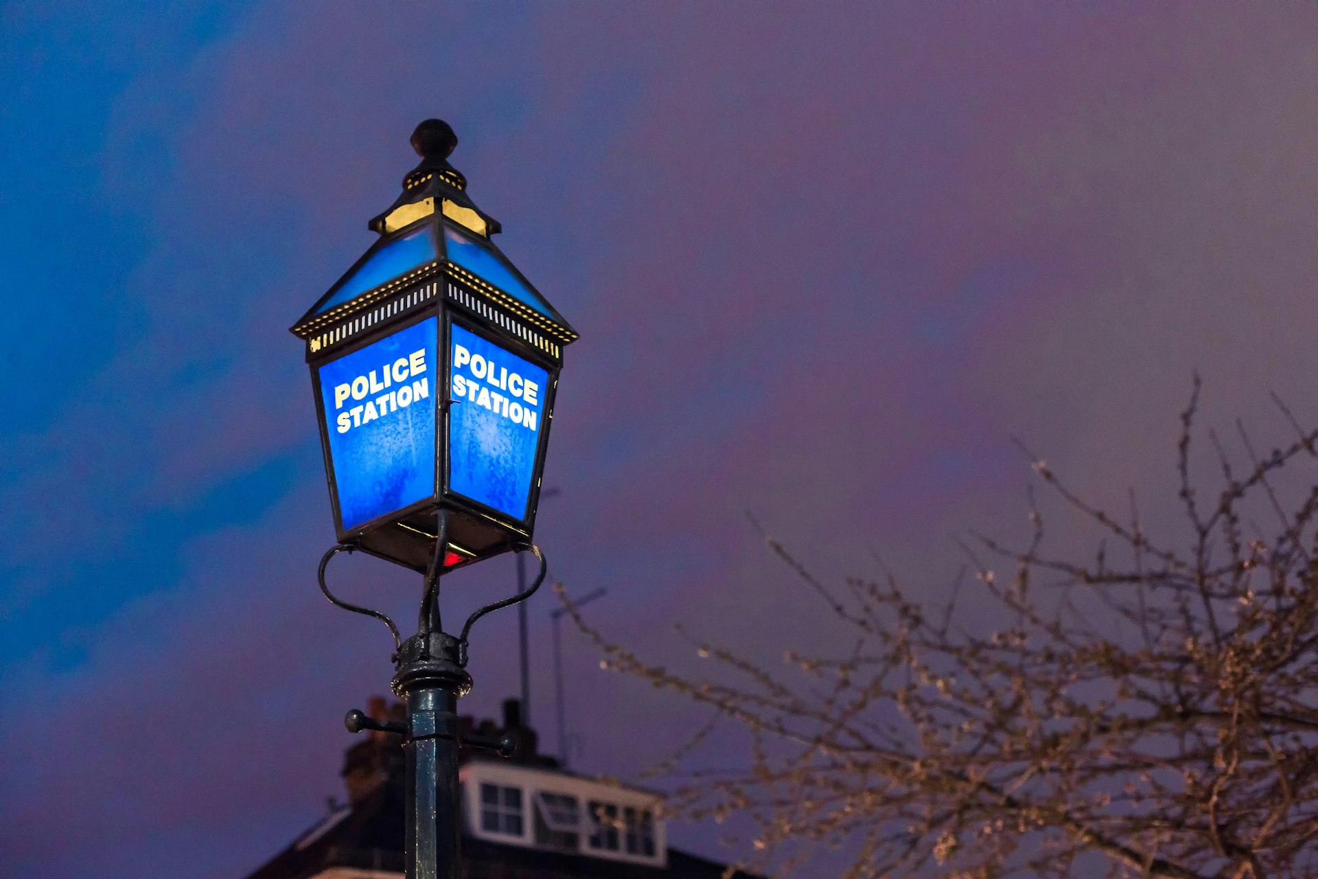 a street light with a blue light on top of it